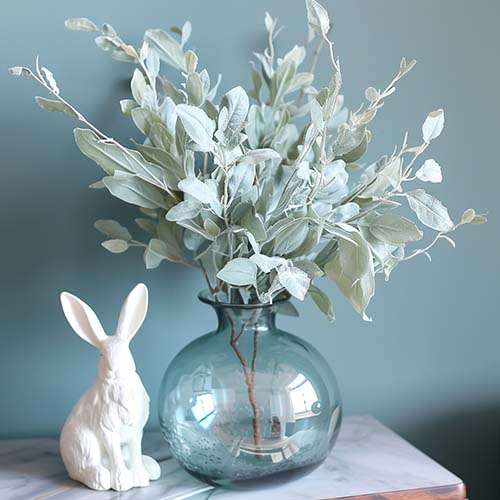 spring table centerpieces bunny and blue vase with eucalyptus